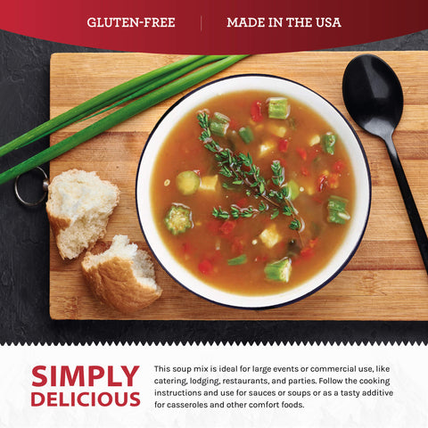 Bowl of gluten-free chicken gumbo soup with vegetables, fresh bread, and green onions on a wooden board