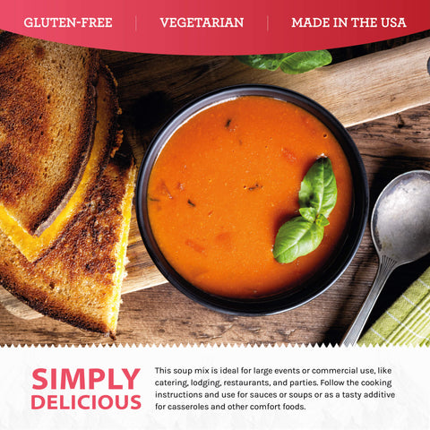 Tomato basil soup in black bowl with fresh basil and grilled cheese on rustic wood table
