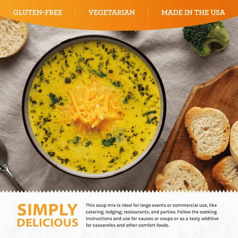 Broccoli cheese soup in a bowl topped with shredded cheese, served with bread and broccoli.